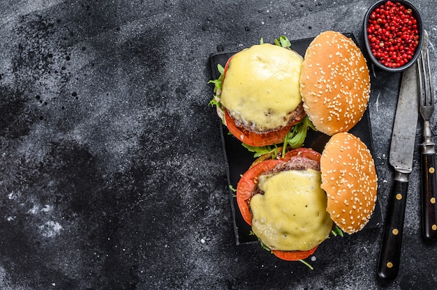 homemade beef burgers with cheese, greens, and onion