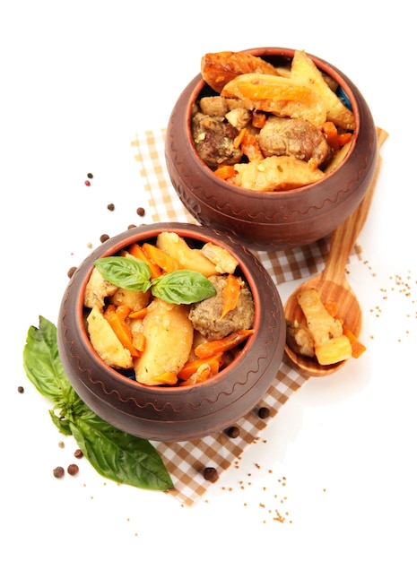 Homemade beef stir fry with vegetables in pots isolated on white