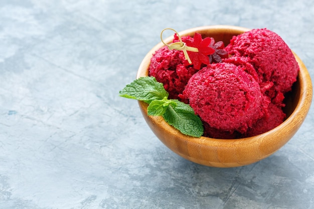 Homemade beetroot ice cream in a wooden bowl