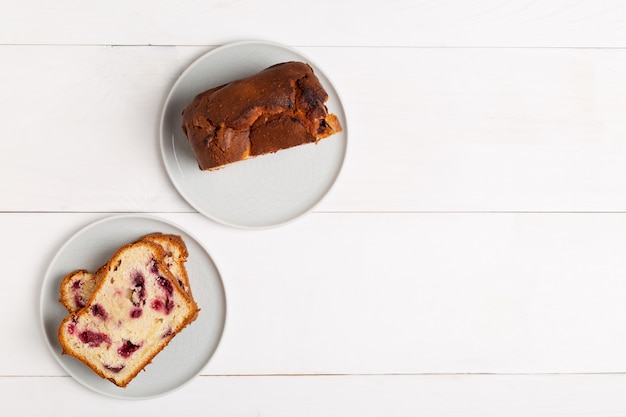 Homemade berry cake on white wooden background