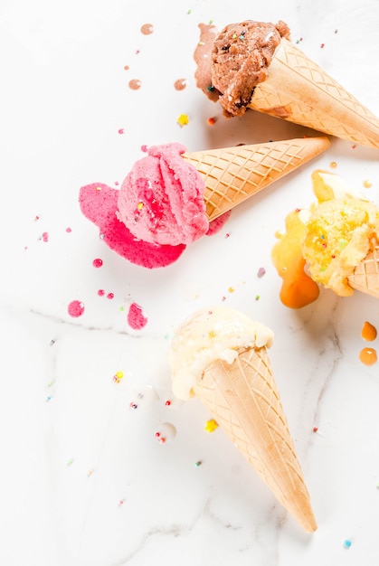 Homemade berry vanilla caramel chocolate ice cream in waffle cones