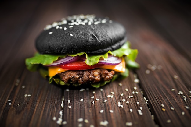 Homemade Black Burger with Cheese. Cheeseburger with black bun