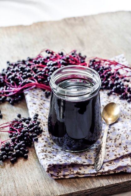 Homemade black elderberry syrup in glass jar