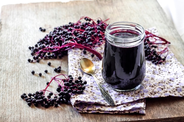 Homemade black elderberry syrup in glass jar