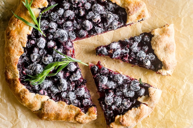 Homemade blackcurrant galette on old concrete background