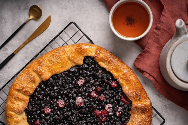 Homemade blueberry galette tart on the table with tea