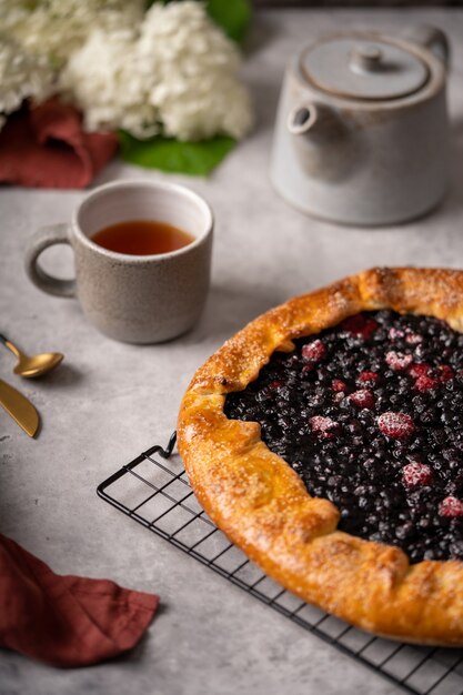 Homemade blueberry galette tart on the table with tea