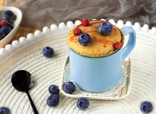 homemade blueberry muffin mug cake with fresh berries. vanilla mugcake dessert. Easy to cook