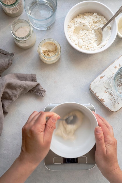 Homemade breadmaking with sourdough using wild yeast busy lifestyle scene of baking at home top view Sustainable living