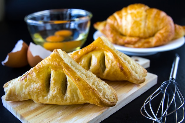 Homemade breads or bun on wood background, croissant puff and pies, breakfast food