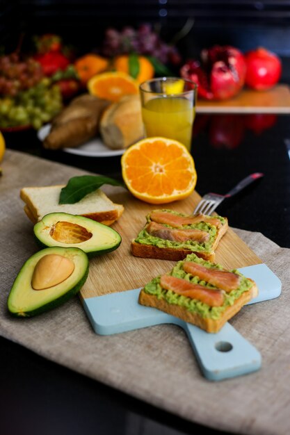 Homemade breakfast with avocado bread and fruit