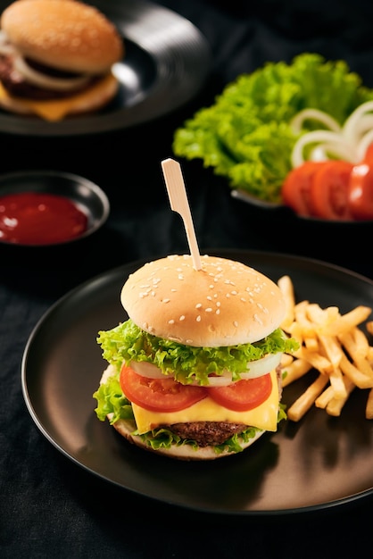 Homemade burger and cheese with fries and icy soft drink