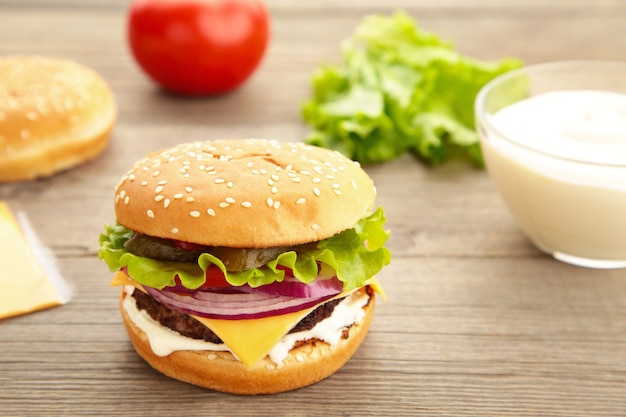 Homemade burger ingredients arranged on wooden. Top view