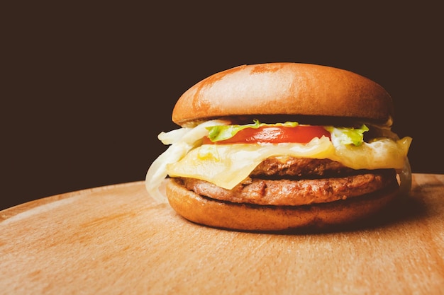 Homemade burger with beef on wooden background Vintage photo processing