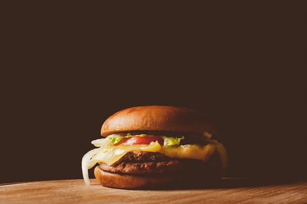 Homemade burger with beef on wooden background Vintage photo processing