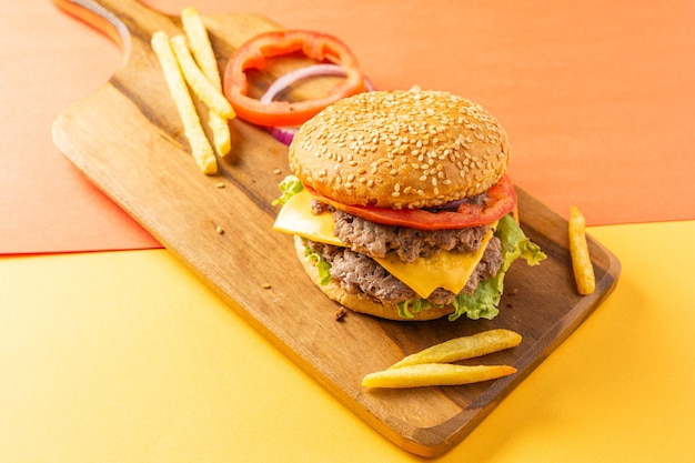 Homemade burger with two meats cheese lettuce tomato and onion