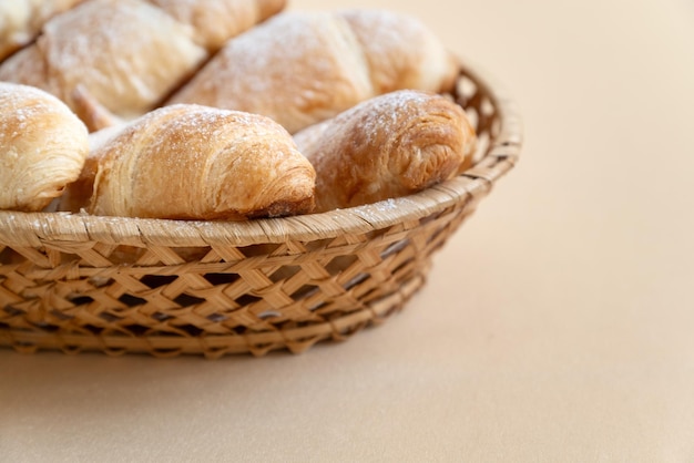 Homemade butter croissants on wicker tray