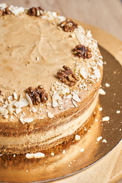 Homemade caramel cake on table. Wooden background.