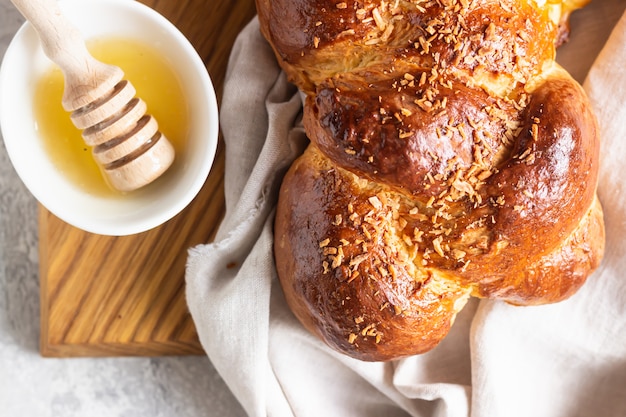 Homemade challah bread on a wooden cutting board