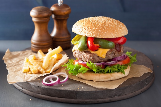 Homemade cheese burger with peppers, tomato and onion