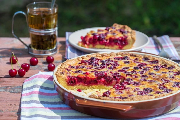 Homemade cherry pie on rustic background close up