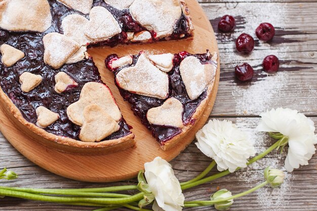 Homemade cherry pie on rustic background