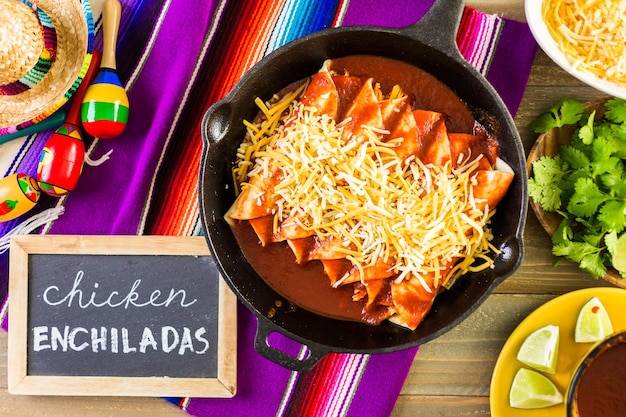 Homemade chicken enchiladas in cast iron frying pan.