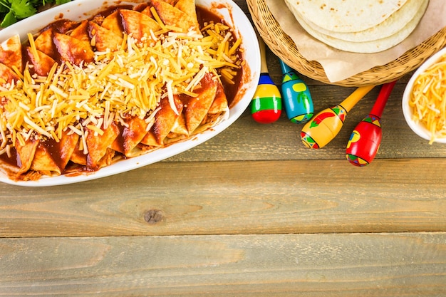 Homemade chicken enchiladas in a white casserole dish.