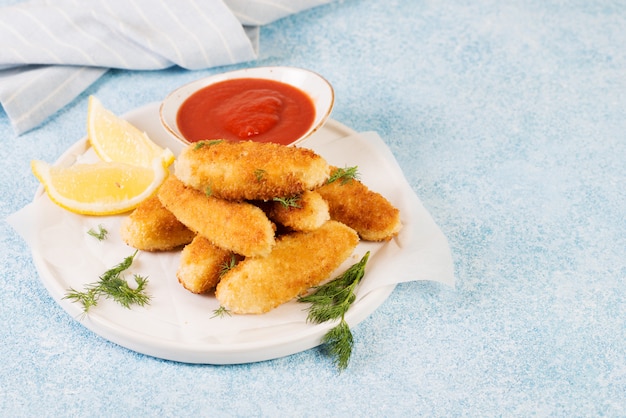 Homemade chicken nuggets with tomato sauce.