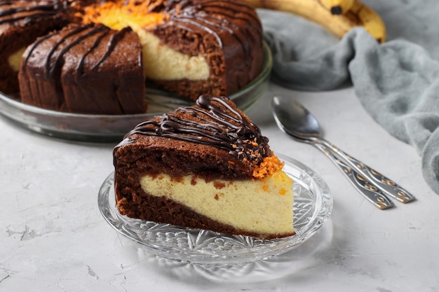 Homemade Chocolate Cake with cottage cheese and banana filling with a piece of cake cut off in the foreground