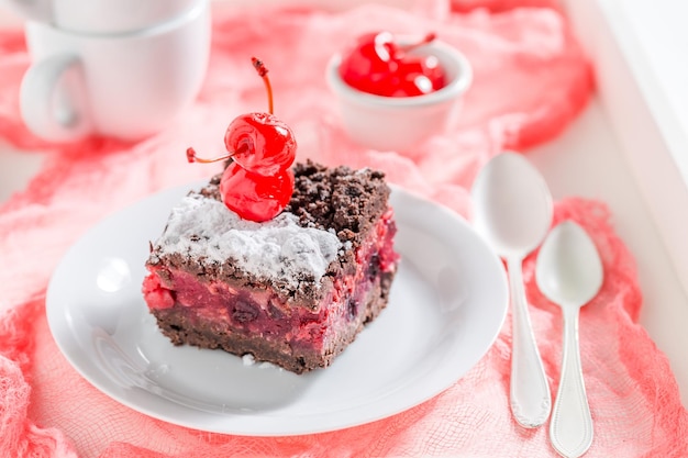 Homemade chocolate cake with crumble and cherry