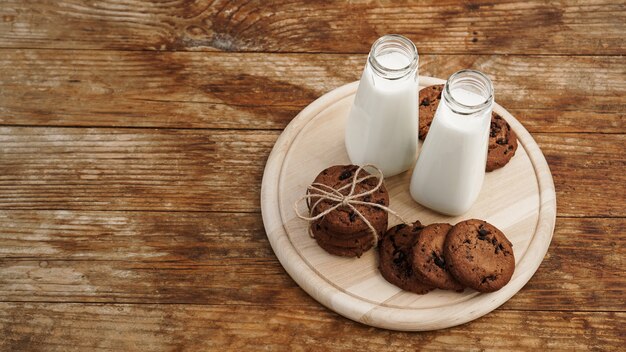 Homemade Chocolate Chip Cookies and Milk on wooden background in rustic style. Sweet snack. Place for text