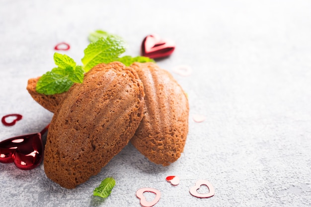 Homemade chocolate cookies Madeleine with mint and Valentine's day decorations. Holidays food surface with copy space for text