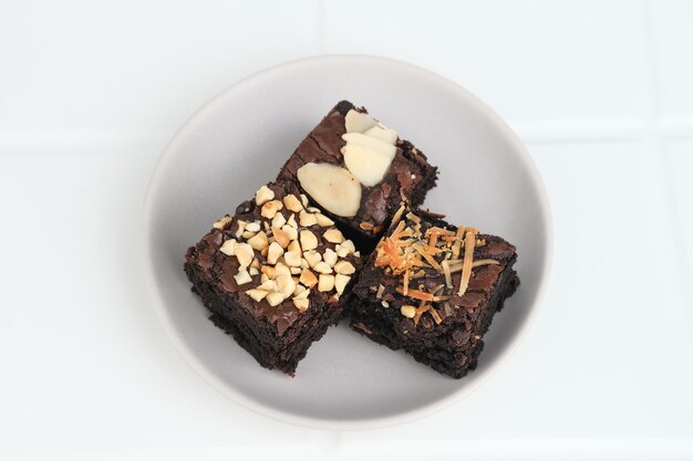 Homemade chocolate fudge brownie with mix topping close up selected focus