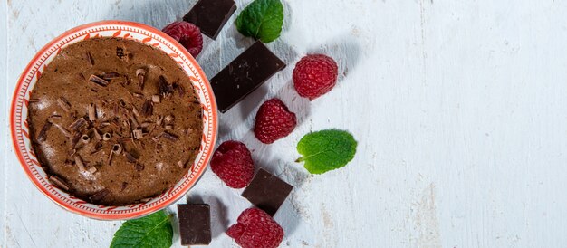 Homemade chocolate mousse with fresh raspberries