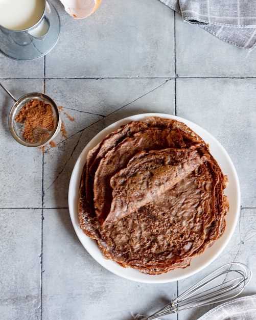 Homemade chocolate pancakes on a gray background