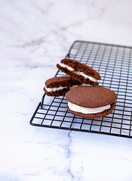 Homemade chocolate sandwich cookies Light marble background Selective focus