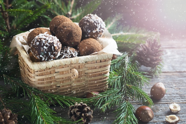 Homemade chocolate truffles with cocoa and coconut in a basket