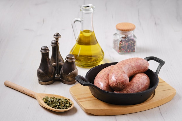 Homemade classic raw beef sausage in cast iron skillet