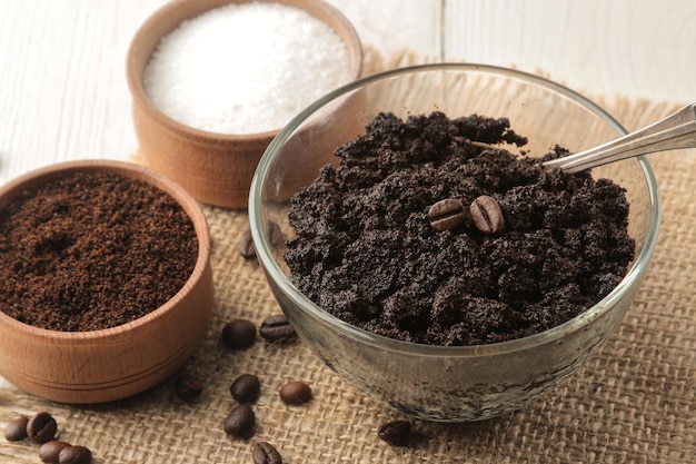 Homemade coffee scrub in a jar for the face and body and various ingredients for making scrub on a light background spa cosmetics care cosmetics