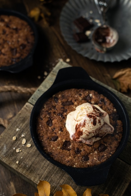 Homemade comfort food, giant skillet cookie with chocolate chips and ice cream, top view