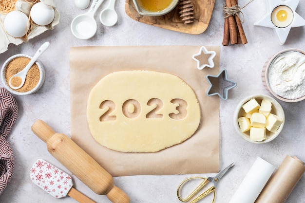 Homemade cookie dough in the form of numbers 2023 The concept of baking for New Year and Christmas