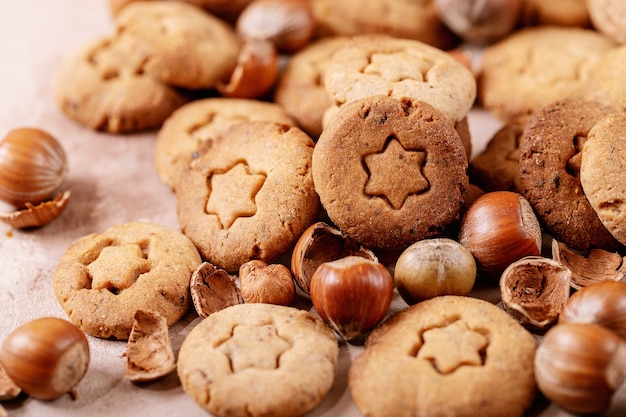 Homemade cookies with hazelnuts on white texture background