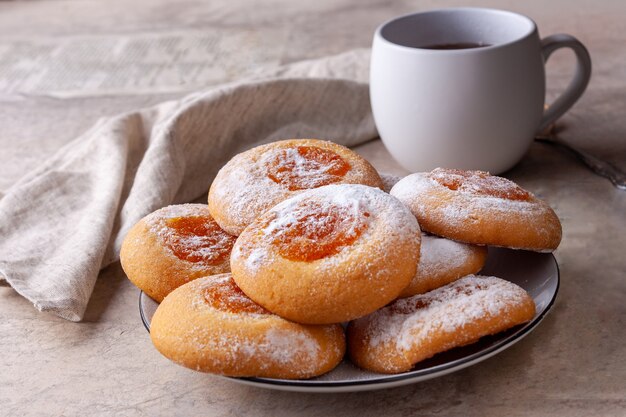 Homemade cookies with orange jam lies in a plate on the table