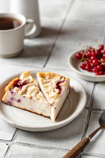 Homemade cottage cheese casserole with berries on gray tile background