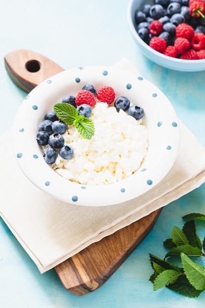 Homemade Cottage cheese with berries and mint Cottage cheese in a bowl Dairy products