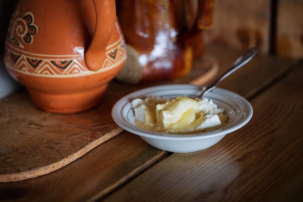 Homemade cottage cheese with sour cream and sugar in a plate