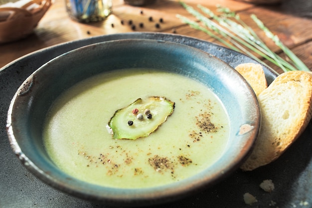 Homemade cream soup with vegetables and bread