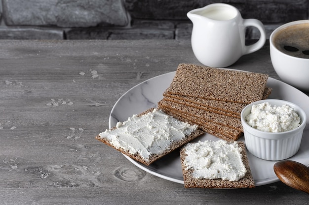 Homemade crispbread toast with cottage cheese and coffee Healthy traditional breakfast concept