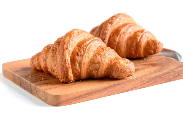 Homemade croissant on wood plate and isolated on white background